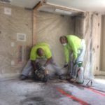 Sawcutting a plumbing trench for a new bathroom during a home renovation in Newport, RI.