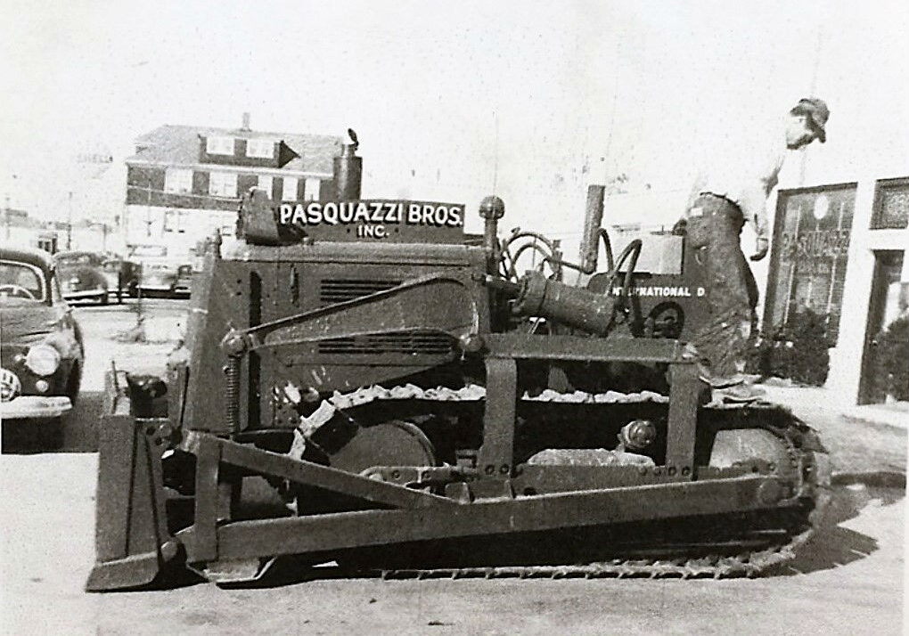 Frank Pasquazzi climbing down from a bulldozer c. 1955